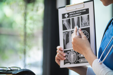 female doctor is reviewing documents to review and diagnose illness and female doctor has determined guidelines for initial treatment when the patient symptoms become more severe. Copy Space for text