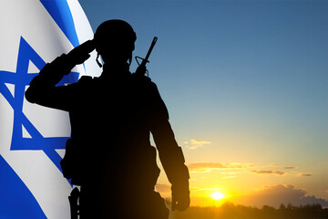 Silhouette of soldier with Israel flag against the sunset. Concept - Armed Forces of Israel