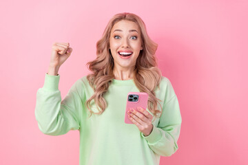 Fototapeta premium Photo of funny woman fist up hooray receive message invite offer linkedin advert manager job celebrate isolated on pink color background
