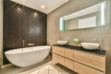 a bathroom with two sinks and a bathtub in the middle one sink is on the right side of the photo