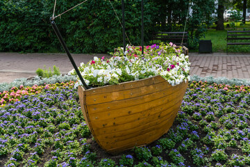 Kostroma, Russia, July 8, 2023. A flowerbed with flowers in the shape of a boat in the park.