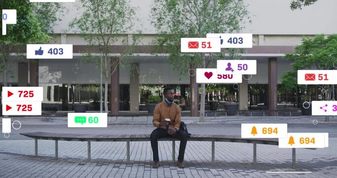 Animation of social media icons over african american man drinking coffee sitting on bench on street