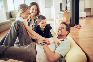 Young happy family playing and having fun in the living room