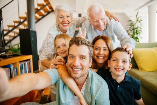 Portrait of a happy multigenerational taking a selfie in the living room