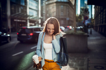 Beautiful stylish young woman shopping in the city