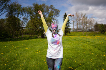 Portrait of happy European woman celebrating Holi with powder colors or gulal.