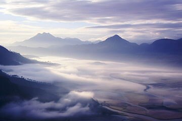 The mountains are in the background and the valley is in the foreground. The photo has a dreamy and peaceful mood. The sky is a mix of blue and purple hues. 