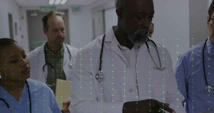 Animation of heart rate monitor over team of diverse doctors, health workers discussing at hospital