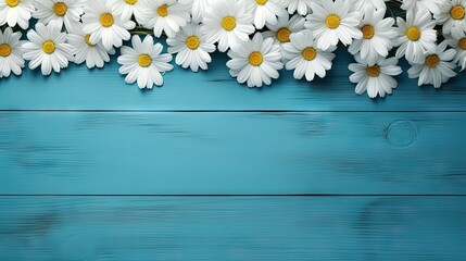 Christian cross and border of white daisy flowers on a blue wood background with copy space