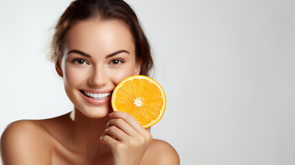 Portrait of young happy smiling woman with fresh orange on white background