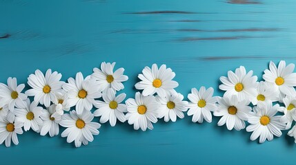 Christian cross and border of white daisy flowers on a blue wood background with copy space