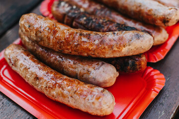 Delicious grilled sausage on a barbecue. Picnic menu. Close-up.