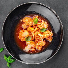 cauliflower in tomato sauce stewed vegetable second course healthy eating appetizer meal food snack on the table copy space food background rustic top view keto or paleo diet vegetarian vegan 