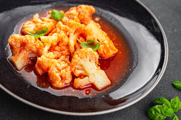 cauliflower in tomato sauce stewed vegetable second course healthy eating appetizer meal food snack on the table copy space food background rustic top view keto or paleo diet vegetarian vegan 