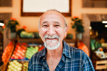 Asian senior man shopping vegetables and fruit at local grocery market. Organic and healthy food store concept
