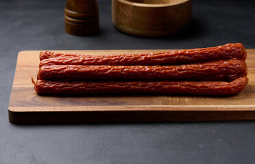 Traditional Polish thin smoked sausages on a black background