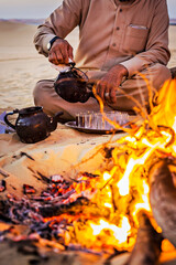 Bedouin tea on the fire in Sahara desert, Egypt - obrazy, fototapety, plakaty