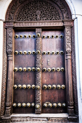 Traditional wooden Zanzibar doors with artistic carving and typical Zanzibar design.