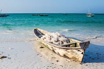 Papier Peint photo Plage de Nungwi, Tanzanie Beautiful Zanzibar coast line. Wooden fisherman boats on sandy beach with blue water background, Zanzibar, Tanzania