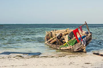 Papier Peint photo Plage de Nungwi, Tanzanie Beautiful Zanzibar coast line. Wooden fisherman boats on sandy beach with blue water background, Zanzibar, Tanzania