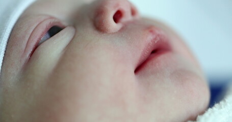 Closeup of newborn baby face first minutes of life