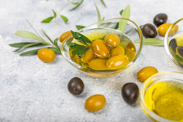Olive oil in a bottle on texture background. Oil bottle with branches and fruits of olives. Place for text. copy space. cooking oil and salad dressing.