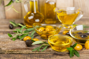 Olive oil in a bottle on texture background. Oil bottle with branches and fruits of olives. Place for text. copy space. cooking oil and salad dressing.