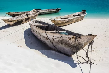 Foto auf Acrylglas Nungwi Strand, Tansania Beautiful Zanzibar coast line. Wooden fisherman boats on sandy beach with blue water background, Zanzibar, Tanzania