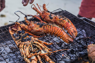 Grilled lobster barbecue on charcoals close up 