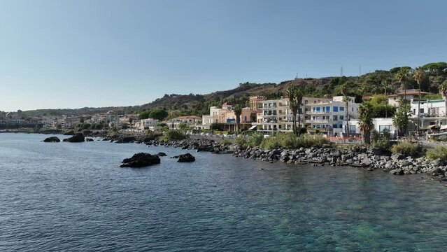 La costa della Sicilia, Italia. Aci Trezza vista dal mare con gli scogli dei Ciclopi.
Ripresa aerea delle località turistiche tra Catania e Taormina.
