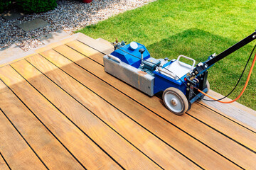 Machine cleaning of a wooden terrace - dry method - grinding the boards with sanding machine,...