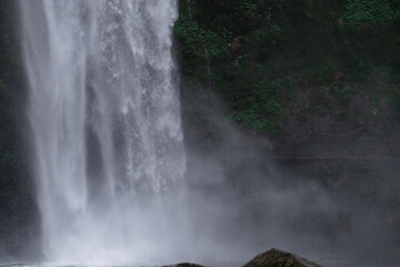 Fototapeta na wymiar Tropical waterfall in Asia in the wild jungle on the island of Bali
