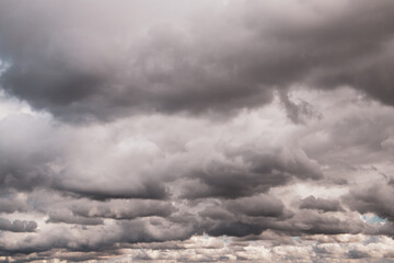 Low gray rain clouds thicken in the sky. The sky before the rain. Fall bad weather, hurricane, dangerous weather conditions, rainy season in October. Abstract natural skyline background. Fresh air.