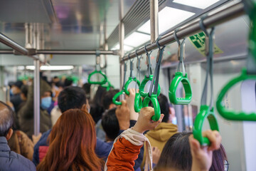 Crowd of passengers on electrical train in Hanoi, Vietnam. Asian people go to work by public...