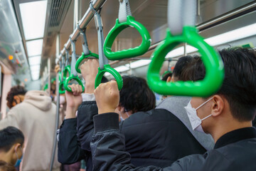 Crowd of passengers on electrical train in Hanoi, Vietnam. Asian people go to work by public...