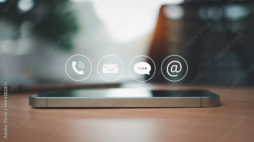 Aufkleber side view of smartphone resting on wooden table surface with communication icons above representing 