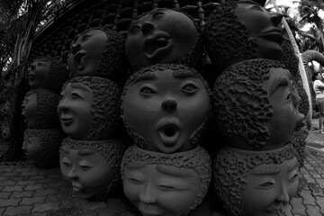 Clay pots in the shape of faces with different emotions