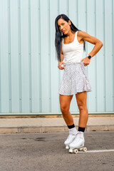 Happy middle aged woman wearing dress smiling while rollerblading asphalt road in sunny day