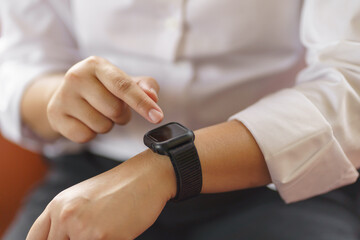 Business woman Looking at smart watch In Office online connect