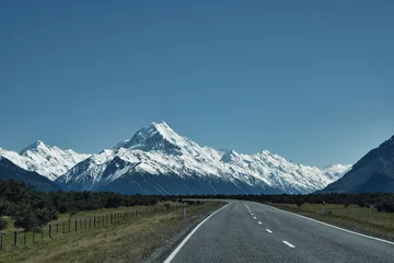Küchenrückwand glas motiv Aoraki/Mount Cook Mount Cook in New Zealand, framed by a road and a flawless blue sky, embodies freedom at its best.