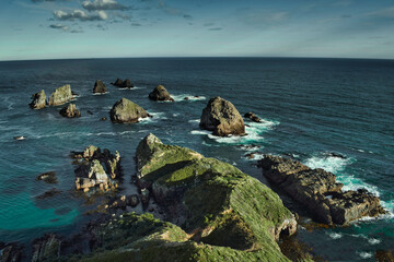 Nugget Point on the southwest coast of New Zealand offers a breathtaking view of the Pacific Ocean....
