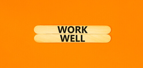 Work well symbol. Concept words Work well on wooden stick. Beautiful orange table orange...