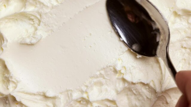 Making swirl with spoon. Texture of fresh, delicious, homemade sour cream, yoghurt. Organic products. Concept of texture of food, taste, organic products