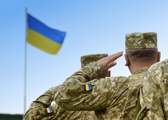 Ukrainian soldiers giving salute. Flag of Ukraine. Ukrainian military.