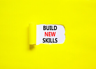 Build new skills symbol. Concept word Build new skills on beautiful white paper. Beautiful yellow table yellow background. Business, education build new skills concept. Copy space.
