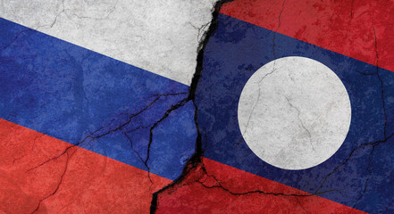 Russia and Laos flags, concrete wall texture with cracks, grunge background, military conflict concept