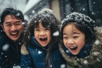 Portrait of Cheerful young father having fun with his kids outside in the snow