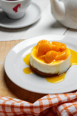 Cake with cream and tangerines on wooden background with towel