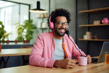 Obraz premium Happy smiling African American blogger hosting a podcast in the studio. An influencer uses a studio to record a podcast for the channel and subscribers. Vlogger shoots video using modern equipment.
