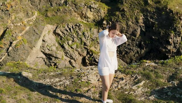 Beautiful Female Tourist Standing On Coastal Cliff Near Ferrol In Galicia, Spain. slowmotion